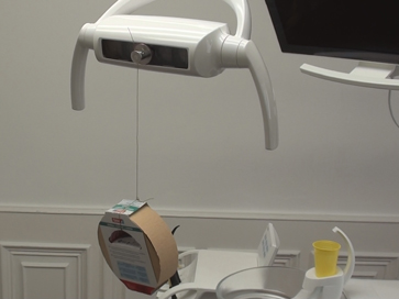 weight hanging from dental light head